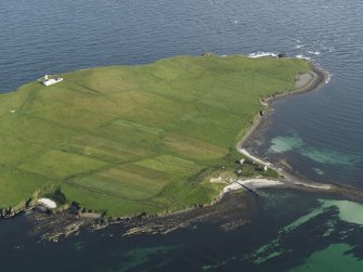 Oblique aerial view on Copinsay showing the lighthouse and field system, taken from the N.