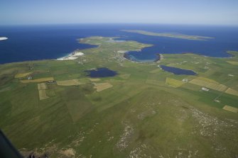 General oblique aerial view of the NE end of Westray with Papa Westray beyond,  taken from the SW.