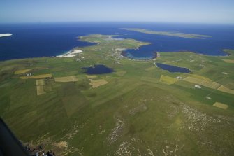 General oblique aerial view of the NE end of Westray with Papa Westray beyond,  taken from the SW.