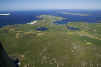 General oblique aerial view of the NE end of Westray with Papa Westray beyond,  taken from the SW.