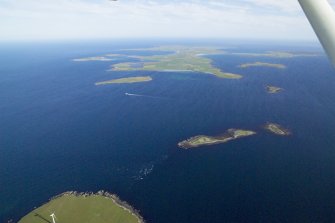 General oblique aerial view of Stronsay across Spurness Sound, taken from the NW.