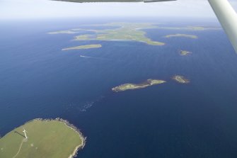 General oblique aerial view of Stronsay across Spurness Sound, taken from the NW.