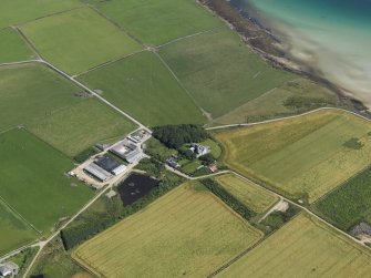 Oblque aerial view centred on Swanbister House with Hillock of Breakna broch adjacent, taken from the WNW.
