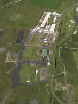 Oblique aerial view centred on the technical area with the frabrication yard adjacent, taken from the SSE.