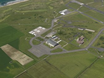 General oblique aerial view centred on the 'Gaydon' aircraft hangar with the USN base adjacent, taken from the SE.