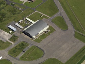 Oblique aerial view centred on the 'Gaydon' aircraft hangar, taken from the SW.