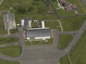 Oblique aerial view centred on the 'Gaydon' aircraft hangar, taken from the S.