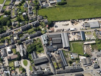 Oblique aerial view centred on the distillery with the bonded warehouses adjacent, taken from the ENE.