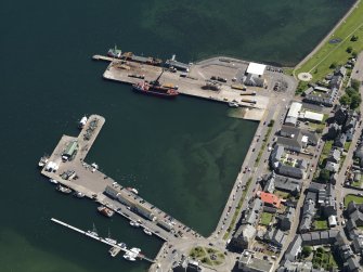 Oblique aerial view centred on the harbour, taken from the NW.