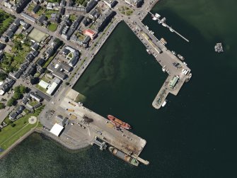 Oblique aerial view centred on the harbour, taken from the E.