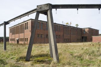 Detail of the overhead transport system with the main pulping and blending house in the background.