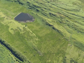 General oblique aerial view centred on the remains of rig and furrow cultivation, taken from the N.