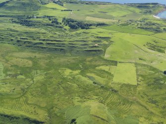 General oblique aerial view centred on the remains of rig and furrow cultivation, taken from the NE.