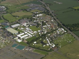 General oblique aerial view centred on the showground, taken from the NW.