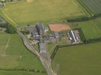 Oblique aerial view centred on the school/community centre with the primary school adjacent, taken from the SSW.