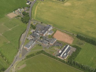 Oblique aerial view centred on the school/community centre with the primary school adjacent, taken from the SE.