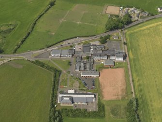 Oblique aerial view centred on the school/community centre with the primary school adjacent, taken from the E.