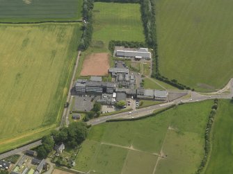 Oblique aerial view centred on the school/community centre with the primary school adjacent, taken from the W.