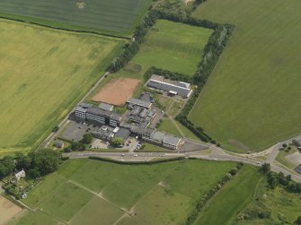 Oblique aerial view centred on the school/community centre with the primary school adjacent, taken from the WSW.