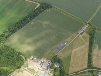 Oblique aerial view of the cropmarks of the settlement and barrows, with the Luffness Mains cottages adjacent, taken from the SW.