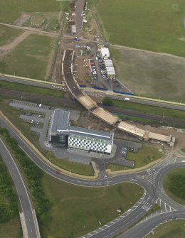 Oblique aerial view of the construction of the bridge on the Edinburgh Tram at Cultin's Road, Hermiston Gait, taken from the SSE.