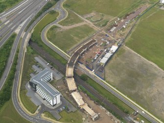 Oblique aerial view of the construction of the bridge on the Edinburgh Tram at Cultin's Road, Hermiston Gait, taken from the SE.