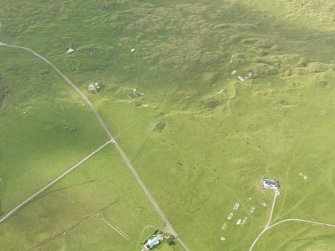 Oblique aerial view centred on the remains of the huts, taken from the NE.
