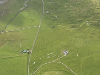 Oblique aerial view centred on the remains of the huts, taken from the N.