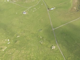 Oblique aerial view centred on the remains of the huts, taken from the SW.