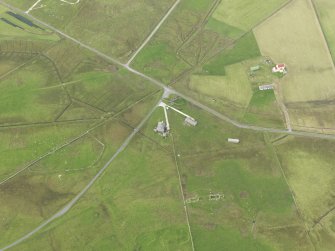 Oblique aerial view centred on the remains of the radar station buildings with the remains of the croft adajacent, taken from the NE.