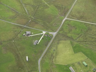 Oblique aerial view centred on the remains of the radar station buildings, taken from the N.