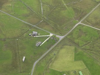 Oblique aerial view centred on the remains of the radar station buildings, taken from the N.