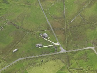 Oblique aerial view centred on the remains of the radar station buildings, taken from the NW.