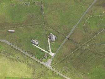 Oblique aerial view centred on the remains of the radar station buildings with the remains of the croft adajacent, taken from the W.