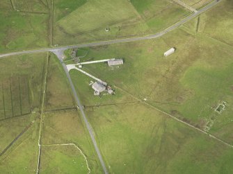 Oblique aerial view centred on the remains of the radar station buildings with the remains of the croft adajacent, taken from the ESE.