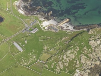 Oblique aerial view centred on Hynish farm steading with Hynish farmhouse adjacent, taken from the SSW.