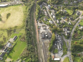 Oblique aerial view centred on the railway station, taken from the E.