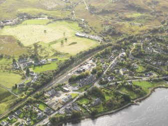 General oblique aerial view centred on the railway station, taken from the NE.