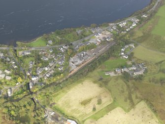 General oblique aerial view centred on the railway station, taken from the SW.