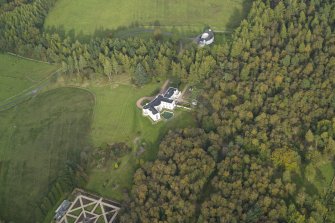 Oblique aerial view centred on the country house with the garage adjacent, taken from the SW.