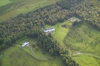 Oblique aerial view centred on the country house with the garage adjacent, taken from the NE.