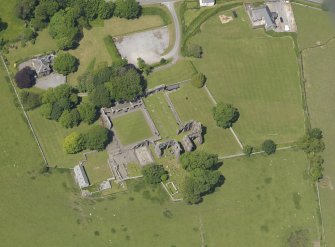 Oblique aerial view of Dundrennan Abbey, taken from the SE.