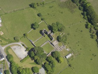Oblique aerial view of Dundrennan Abbey, taken from the SW.