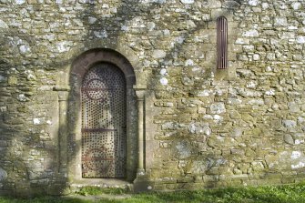 Detail of main doorway and arched window on S elevation of Cruggleton Old Parish Church