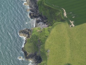 Oblique aerial view of Cruggleton Castle, taken from the NE.
