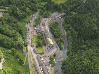 General oblique aerial view of New Lanark centred on the roof garden, taken from the NW.