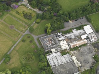 Oblique aerial view of Eglinton Country Park stables, taken from the SW.