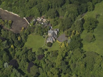 Oblique aerial view of Treesbank House and stables, taken from the SE.