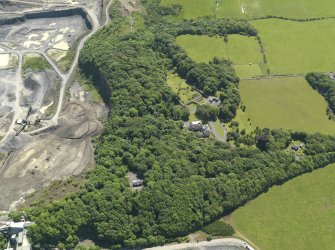 General oblique aerial view of Hillhouse with the Whinstone quarry adjacent, taken from the NW.