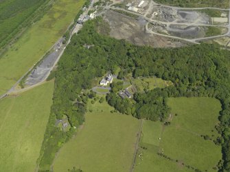 General oblique aerial view of Hillhouse with the Whinstone quarry adjacent, taken from the SSW.